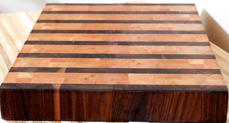 End-grain cutting board with a checkerboard pattern of walnut, maple and cherry