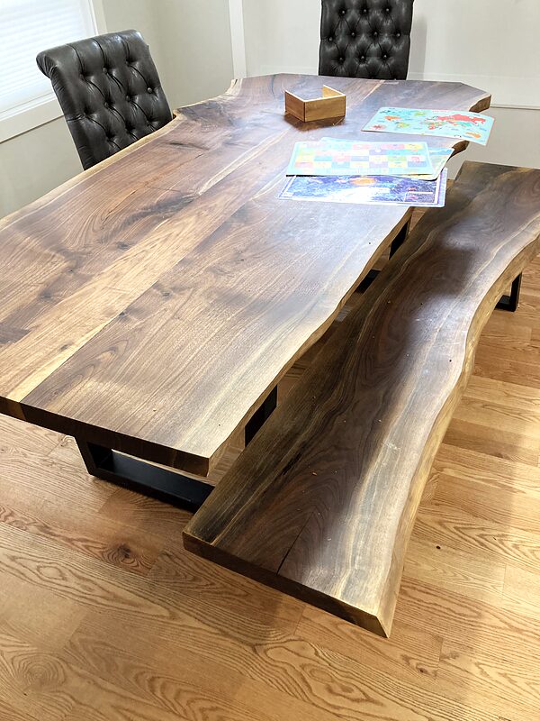 Live-edge walnut dining table with six chairs in a bright dining room