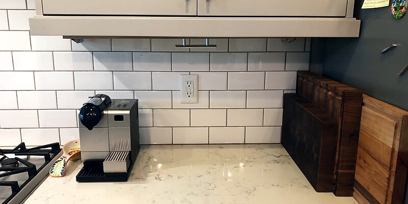 Hidden knife shelf closed: a slim panel under the cabinets above a clear counter